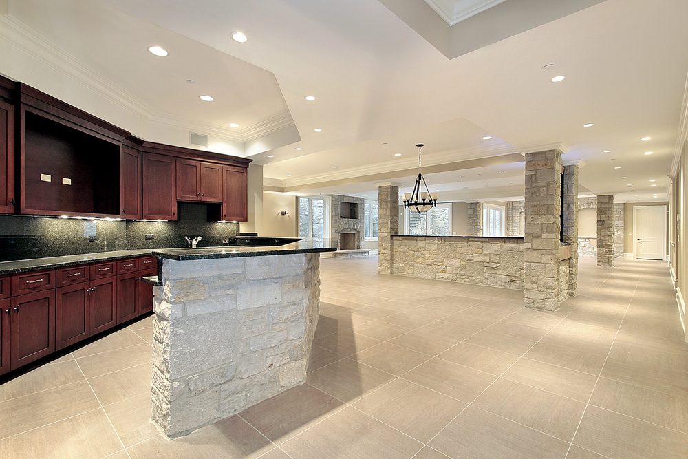 Lower level stone  bar with kitchen and fireplace