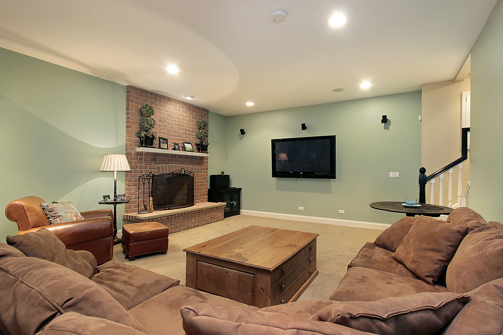 Lower level family room with stone fireplace and large screen TV