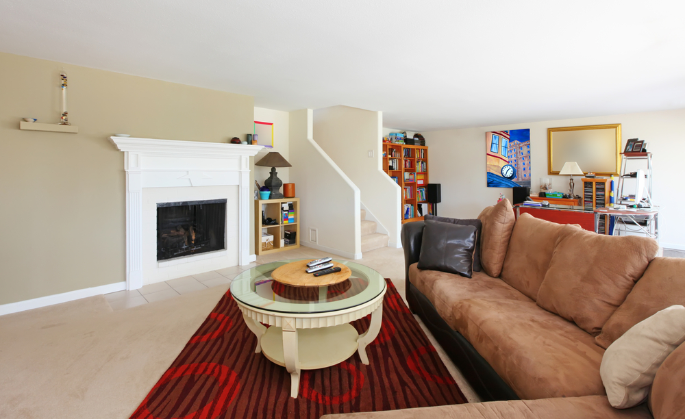 Large living room in the basement with fireplace.