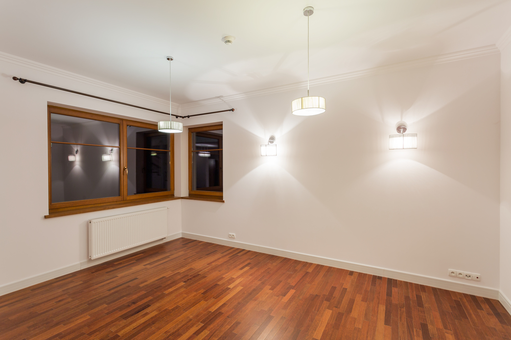 Big unfurnished living room with wooden floor