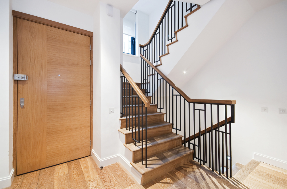 entrance door and modern staircase with a nice wooden finish